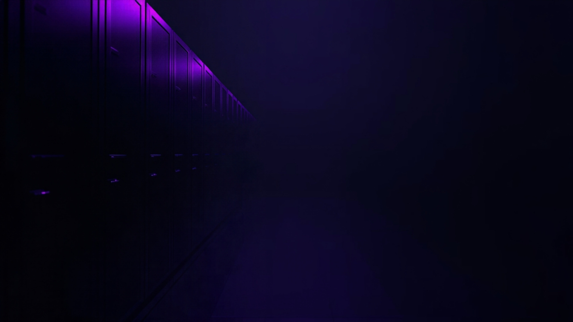 Row of storage cabinets dissolving into darkness at one end in a violet-lit hall